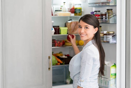 refrigerator door seal faulty food in fridge with lady reaching for apple