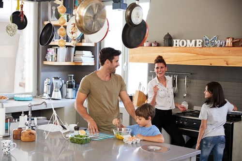 family with home warranties cooking in kitchen with insured appliances